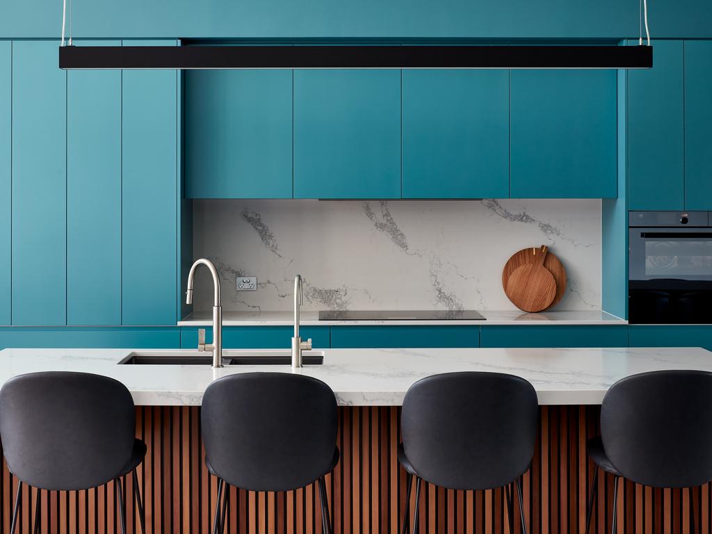 The kitchen is resplendent in lively blue/green cabinets. Photographer: Luc Remond. Architect: Adam Hobbs