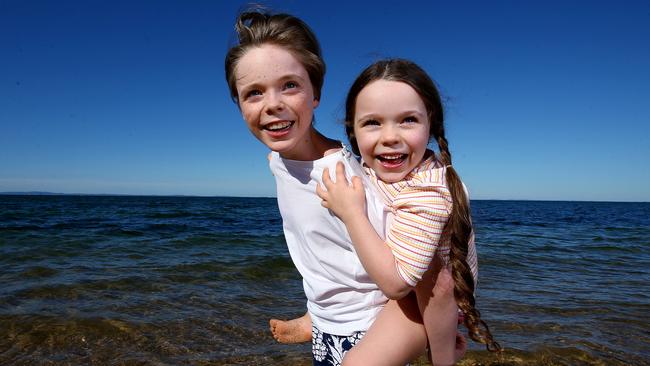 Piper 6 and Joshua 13 Seymour love growing up in Queensland and especially at the beach at Woody Point where they live. Picture: Adam Head