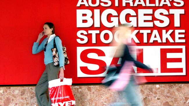 Generic of woman shopper with Myer stocktake sale shopping bag, walking past the Myer, Mall, department store in Brisbane, during end of financial year sale.