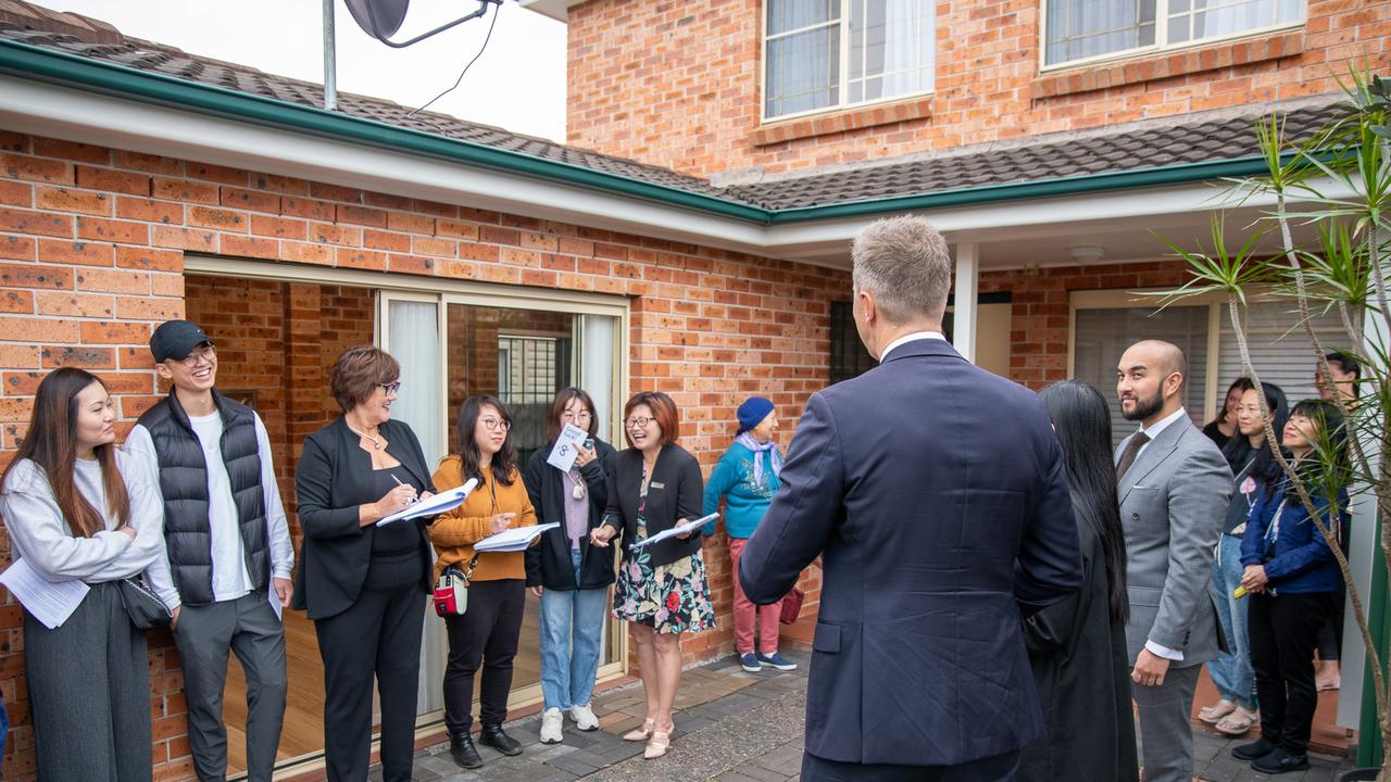 The McGrath agents had six registered parties at the hot auction in North Parramatta. Picture Thomas Lisson