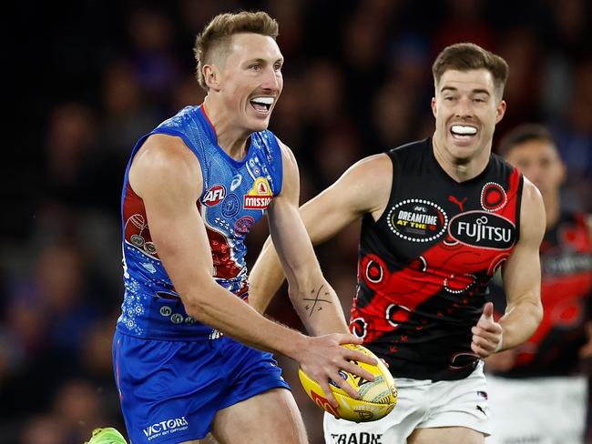 MELBOURNE, AUSTRALIA - MAY 17: Bailey Dale of the Bulldogs is chased by Zach Merrett of the Bombers during the 2025 AFL Round 10 match between the Western Bulldogs and the Essendon Bombers at Marvel Stadium on May 17, 2025 in Melbourne, Australia. (Photo by Michael Willson/AFL Photos via Getty Images)
