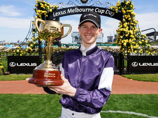 This handout photo taken and released on November 3, 2020 by Racing Photos shows Jye McNeil, who rode Twilight Payment of Ireland, celebrating with the trophy after winning the Melbourne Cup at Flemington Racecourse in Melbourne. (Photo by Scott Barbour / RACING PHOTOS / AFP) / XGTY / EDITORS NOTE ----RESTRICTED TO EDITORIAL USE MANDATORY CREDIT " AFP PHOTO /SCOTT BARBOUR / RACING PHOTOS" NO MARKETING NO ADVERTISING CAMPAIGNS - DISTRIBUTED AS A SERVICE TO CLIENTS - NO ARCHIVES