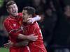 Liverpool's Philippe Coutinho, centre, celebrates with team-mates Alberto Moreno, left, and Raheem Sterling after scoring his side's second goal during their FA Cup Fourth Round Replay match at the Macron Stadium in Bolton, England, Wednesday Feb. 4, 2015. (AP Photo / Peter Byrne, PA) UNITED KINGDOM OUT - NO SALES - NO ARCHIVES