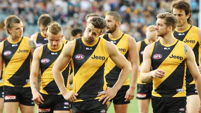 Disappointed Richmond players leave the Adelaide Oval.