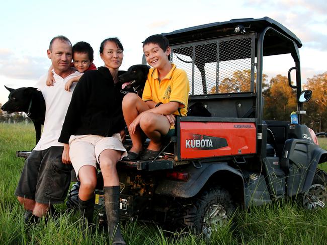 WEEKEND TELEGRAPHS SPECIAL. MUST TALK WITH PIC ED JEFF DARMANIN BEFORE PUBLISHING.,  NSW mid north coast flood disaster. Farmer Darren Croaker with his wife is Rosanne and kids Jack, 9, and Tom, 2 on their property at Oxley Island near Taree. MUST CREDIT Nathan Edwards