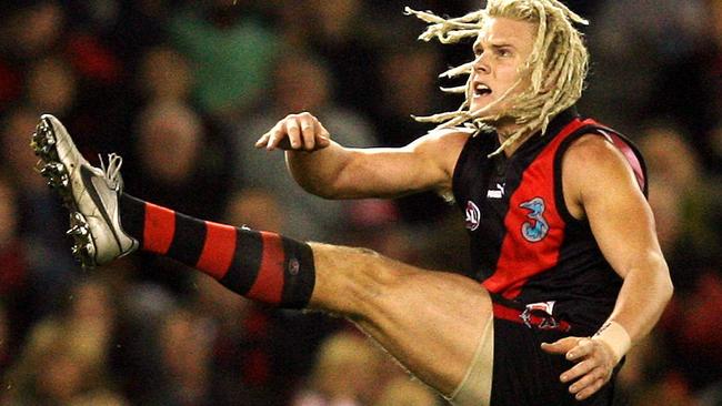 Courtney Johns kicks a goal for Essendon.