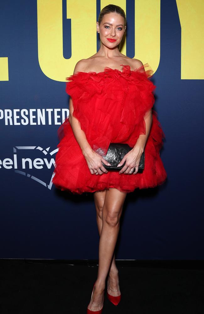 Also at the premier, actress April Rose Pengilly wore a bright red tulle mini dress, which she matched with red pumps and a Louis Vuitton clutch. Picture: Matrix Media Group