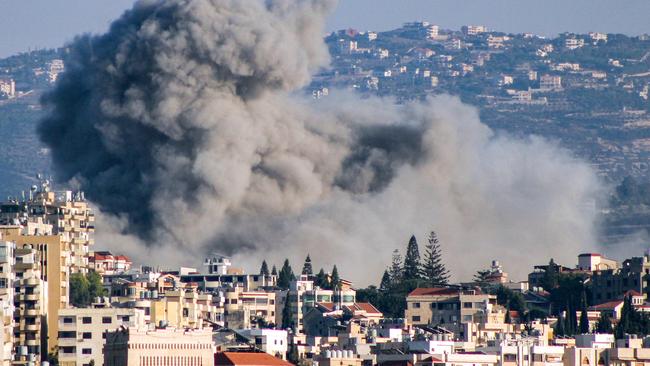 TOPSHOT - Smoke rises following an Israeli air strike on the village of Ain Baal in southern Lebanon on October 29, 2024. Israel expanded operations in Lebanon nearly a year after Hezbollah began exchanging fire in support of its ally, Hamas, following the Palestinian group's deadly attack on Israel on October 7, 2023. (Photo by Kawnat HAJU / AFP)