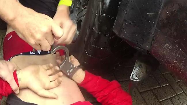 Queensland police officers a man during Operation Dryandra. The operation has arrested 494 people on 2448 charges since the beginning of 2022. Picture: Queensland Police