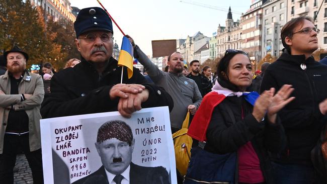 A man holds a placard reading ‘Occupier, thief, liar, bandit, 1968 Breznev, I'm done, 2022 Putin’ with the face of Russian President Vladimir Putin during an anti-war protest in Prague. Picture: AFP