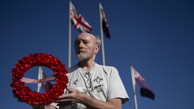 Mic Noble at the Logan war memorial where he has made a photographic tribute which war veterans and their families can view online on Anzac Day AAP/Image Sarah Marshall