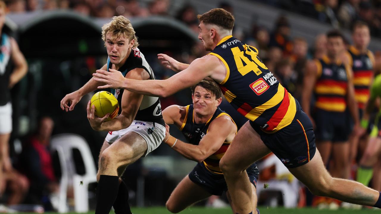 ADELAIDE, AUSTRALIA - MAY 02: Jason Horne-Francis of the Power is tackled by Matt Crouch and Mark Keane of the Crows during the 2024 AFL Round 08 match between the Adelaide Crows and the Port Adelaide Power at Adelaide Oval on May 02, 2024 in Adelaide, Australia. (Photo by James Elsby/AFL Photos via Getty Images)