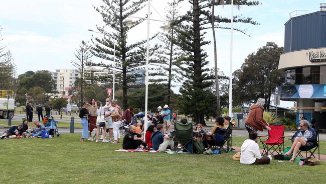 Pictures of families doing Father’s Day over the border barriers at Coolangatta. Picture by Richard Gosling