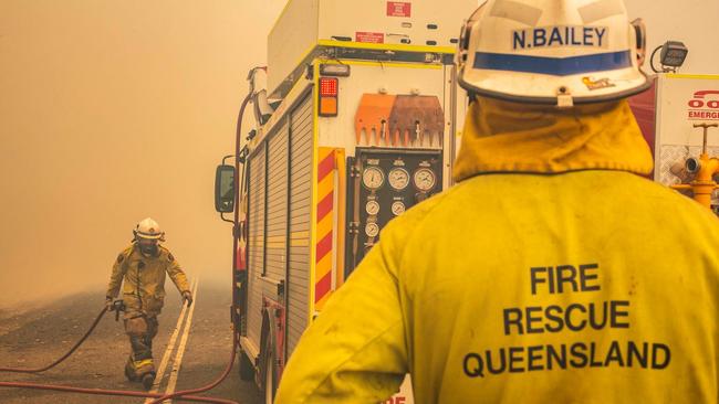 A supplied image obtained on Friday, November 30, 2018, shows a firefighters working to control a bushfire in Deepwater, Central Queensland. Fire conditions in the area are rated as potentially catastrophic with 140 fires burning around the state. (AAP Image/QFES Media) NO ARCHIVING, EDITORIAL USE ONLY