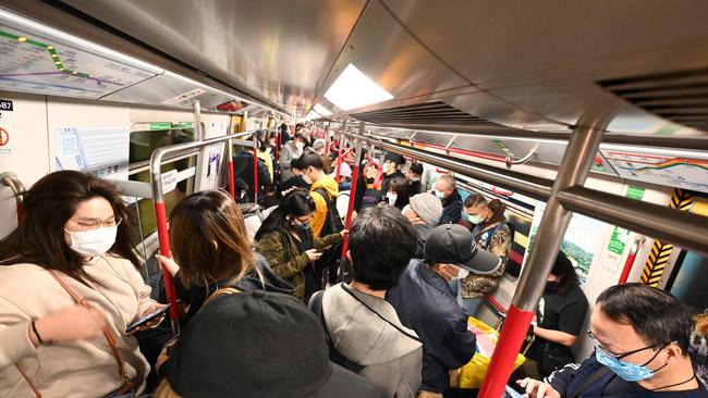 People travel on a crowded underground train in Hong Kong as the city faces its worst Covid-19 outbreak since the start of the pandemic. Picture: AFP.