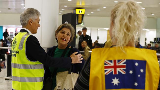 Stephen Smith, Australian High Commissioner to the United Kingdom, greets an Australian citizen evacuated from Israel. Picture: Getty Images