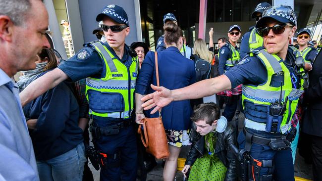 Police usher delegates through the protesters’ lines at the IMARC conference. Picture: Jake Nowakowski.