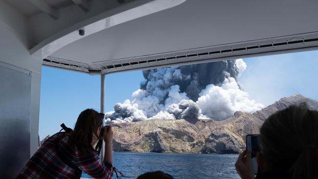 Tourists watch the deadly eruption of the volcano on White Island.