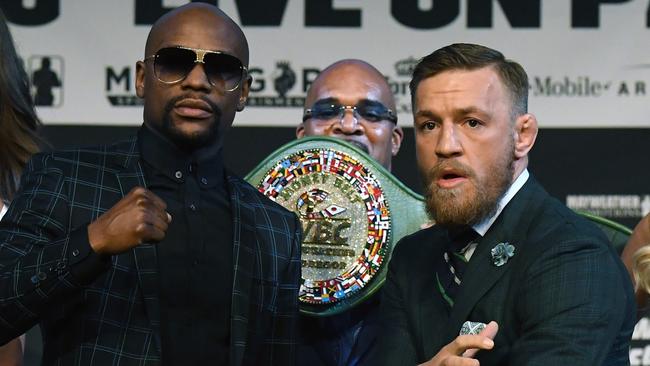 Boxer Floyd Mayweather Jr. (L) and UFC lightweight champion Conor McGregor (R) pose.