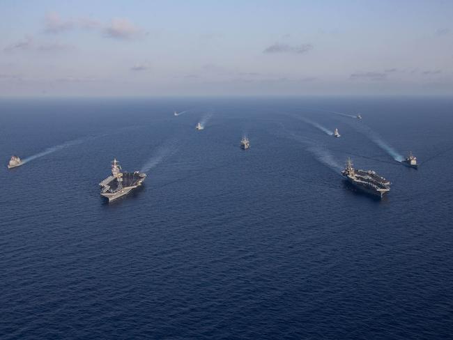 Aircraft carriers Gerald R. Ford (L, front) and Dwight D. Eisenhower (R, front) and ships in their Strike Groups sail in formation in the Mediterranean Sea. Picture: AFP/DOD