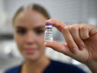 Registered Nurse (RN) Christina O'Donnell holds a vial of the Pfizer COVID-19 vaccine. Picture: Ian Hitchcock