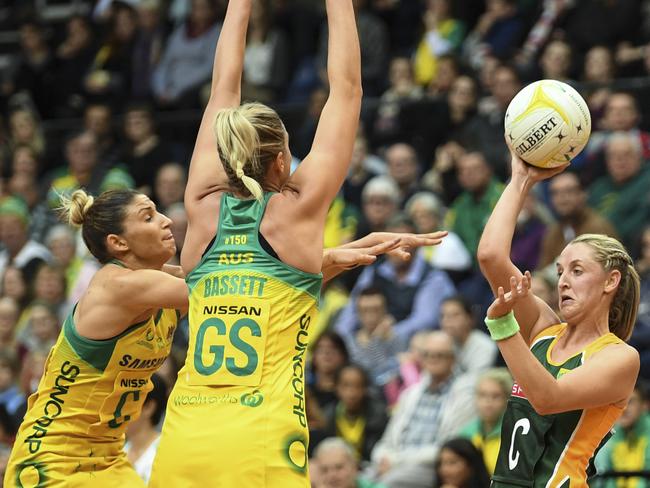 Erin Burger faces off against Caitlin Bassett (centre) and Kim Ravaillion of Australia in a recent Test match.