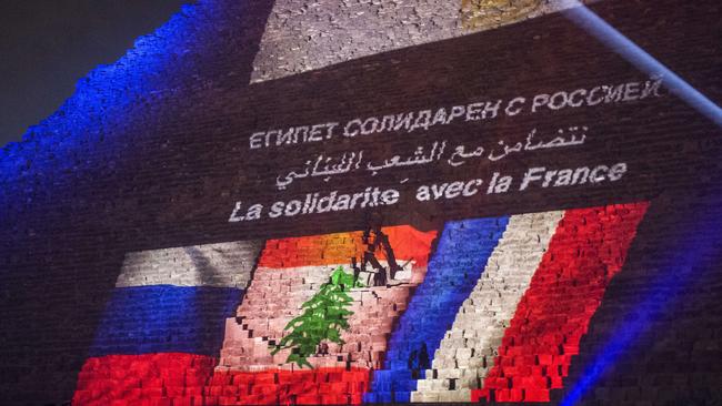 The great pyramid of Khufu is illuminated with the French, Lebanese and Russian flags in Giza, outskirt of Cairo on November 15, 2015, during a ceremony in homage to the victims of attacks in Paris and Beirut and the Sinai plane crash. AFP PHOTO / KHALED DESOUKI