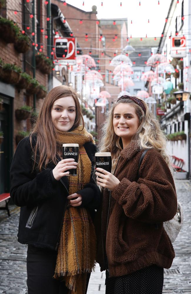 Aisling Farmer, 25, of Boho in Northern Ireland, and Megan Wilkinson, 22, of Belfast, enjoy a drop of Guinness at the historic Duke of York pub in Belfast's old town. Picture: Ella Pellegrini