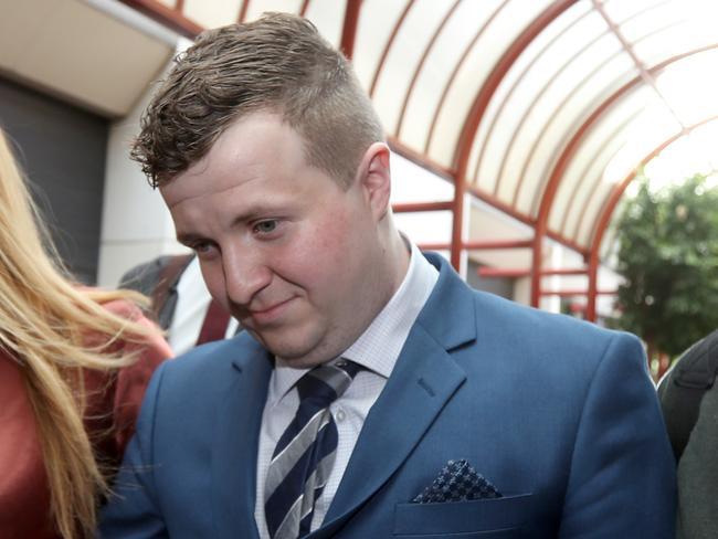 William Russell with supporters leaves the Adelaide district court in Adelaide, Monday, October 14, 2019.  Russell a former Young South Australian of the Year finalist and teen online safety advocate on child sex charges. (AAP Image/Kelly Barnes) NO ARCHIVING