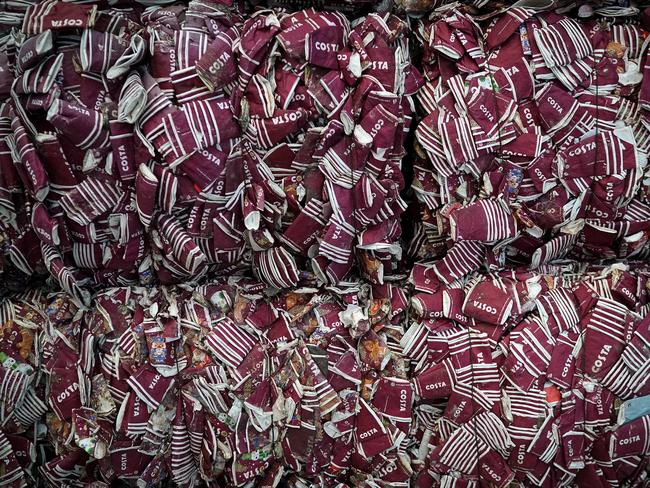 Thousands of takeaway coffee cups wait to be recycled and turned into plastic-free packaging at James Cropper in England — the world’s first recycling process dedicated to upcycling takeaway cups. Picture: Getty