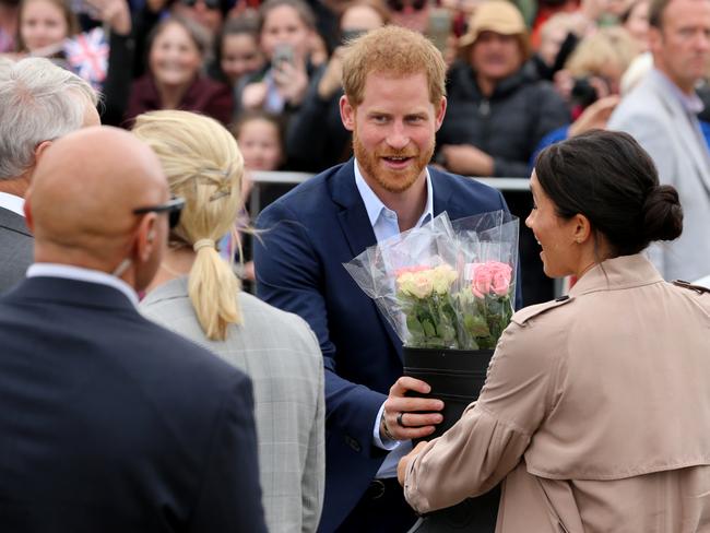 Harry and Meghan were given flowers by ecstatic royal fans during their Auckland walkabout. Picture: Nathan Edwards.