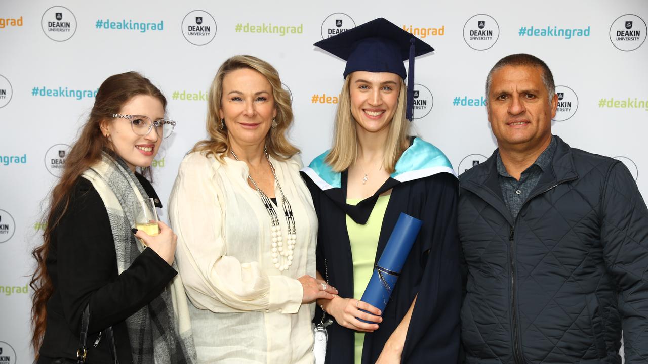 Master graduate Nicola Scarso with sister Cassandra, mum Trish and dad Vince at the Deakin University post-ceremony celebration. Picture: Alison Wynd