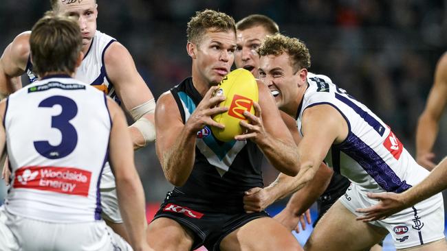 ADELAIDE, AUSTRALIA - APRIL 13:   Dan Houston of the Power  looks to handball during the round five AFL match between Port Adelaide Power and Fremantle Dockers at Adelaide Oval, on April 13, 2024, in Adelaide, Australia. (Photo by Mark Brake/Getty Images)