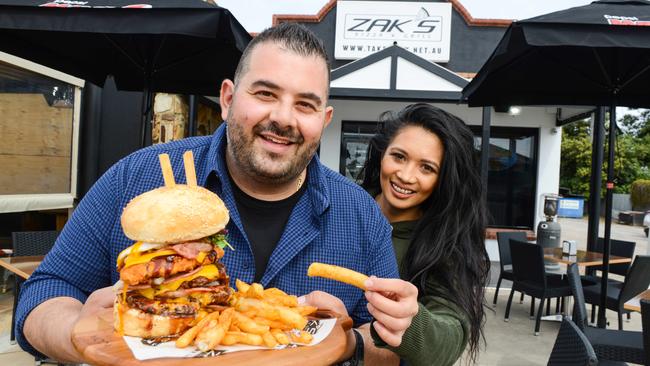 Zak Kartabani and Hanna Paredes outside Zak's Pizza and Grill restaurant in Port Noarlunga South. Picture: AAP/Brenton Edwards