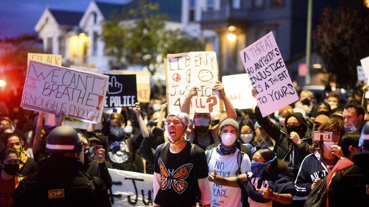 Demonstrators face off against police officers in Oakland, California. Picture: AP P/Noah Berger