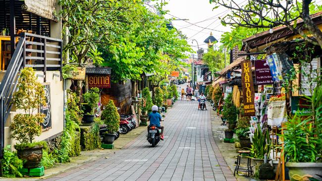 Tourists strolling along the central street of Ubud. Ubud is the cultural heart of Bali. It's full of restaurants, yoga studios, spaÃ¢â‚¬â„¢s and shops. This traditional country town is home to one of Bali's royal families.Escape 7 January 2024Eds LetterPhoto - iStock