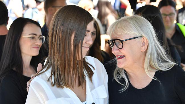 Former government staffer Brittany Higgins, left, who alleged publicly last month that she had been raped by a colleague in a minister's office in 2019, reacts before speaking in front of protesters during a rally against sexual violence and gender inequality in front of Parliament House in Australia's capital city Canberra today. Picture: AFP