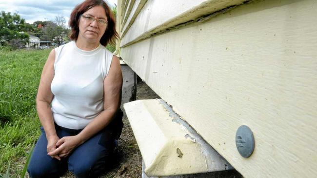 INSURANCE CLAIM: Jessie Harlow inspects the damage to her North Ipswich home she believes was caused by high winds in a storm in October last year. Picture: Rob Williams