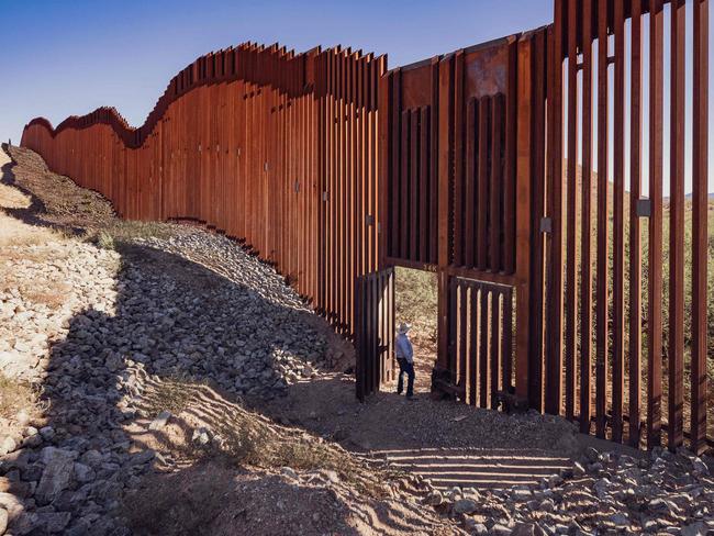 Rancher Timm Klump stands by the border wall built between Arizona and Mexico. Picture: AFP.