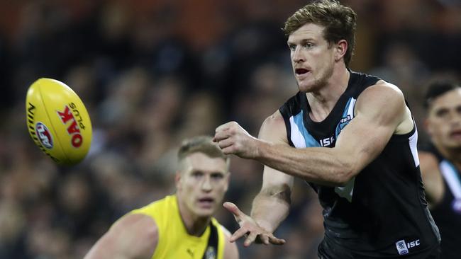 Tom Jonas gets a handball away against Richmond. Picture: Sarah Reed