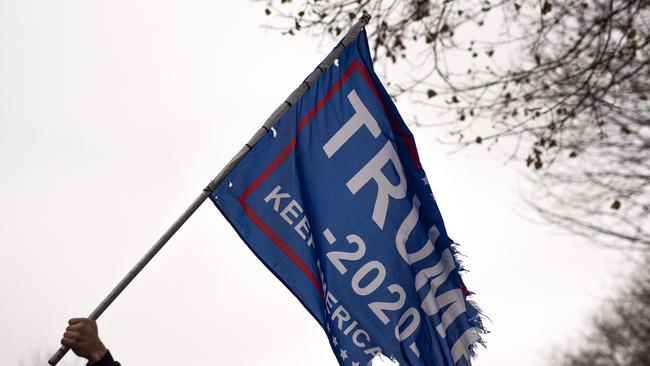 A tattered Trump flag flown at a rally contending the results of the US election. Picture: Stephen Maturen / Getty Images / AFP