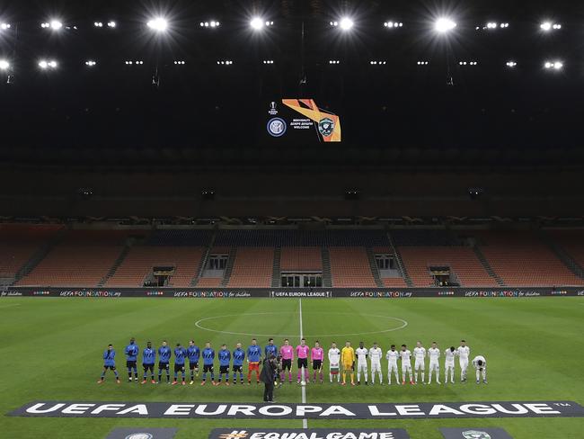 Inter Milan, left, and Ludogorets line-up inside the empty San Siro stadium in Milan, Italy ahead of their Europa League round of 32 second leg soccer match. Inter beat Ludogorets 2-1 in an empty stadium as a precaution because of the virus outbreak in Italy. Picture: AP