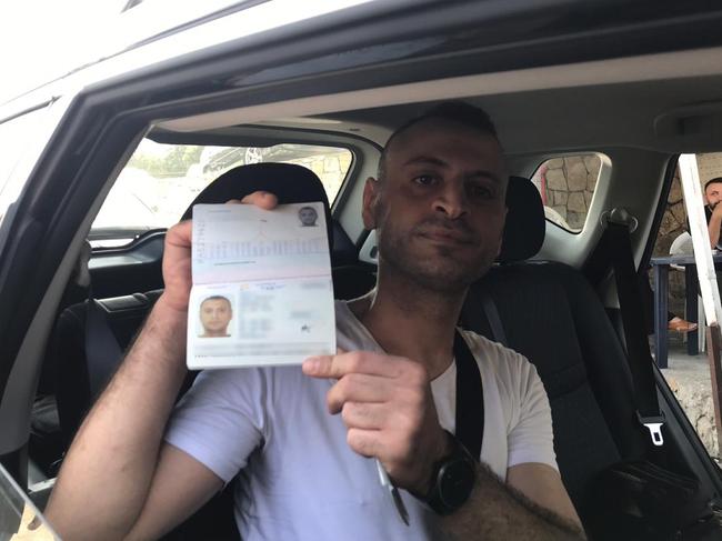 Amer Khayat raises his passport as he leaves a Beirut jail. Picture: Stephen Drill