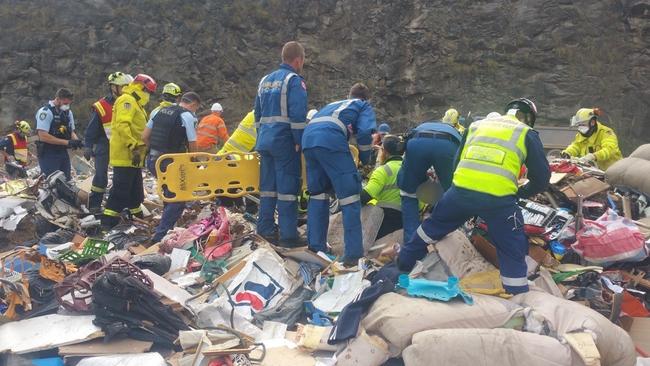 Police and ambulance crews on the scene attend to the injured man.