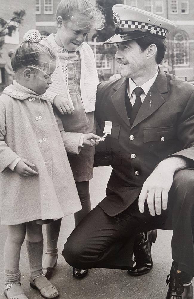 Constable Rod McDonald with his daughters Sarah (left) and Brooke (right) on the day he got his Valour Award after being shot by Pavel "Mad Max" Marinof. Another Victoria Police officer with a similar name, Rod MacDonald, later shot Mad Max dead.