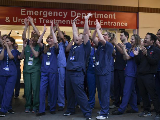 NHS staff applaud outside the Chelsea and Westminster Hospital in London during the weekly "Clap for our Carers", Thursday, April 16, 2020. The applause takes place across Britain every Thursday at 8pm local time to show appreciation for healthcare workers, emergency services, armed services, delivery drivers, shop workers, teachers, waste collectors, manufacturers, postal workers, cleaners, vets, engineers and all those helping people with coronavirus and keeping the country functioning while most people stay at home in the lockdown. (AP Photo/Alberto Pezzali)