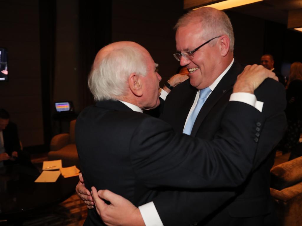 Prime Minister Scott Morrison shares a warm embrace with former PM John Howard in Sydney. Picture: Adam Taylor