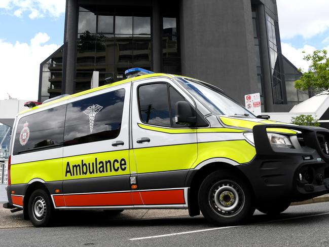 BRISBANE, AUSTRALIA - NewsWire Photos - JANUARY 13, 2021.An Ambulance leaves the Hotel Grand Chancellor in Spring Hill, Brisbane. Guests will be evacuated after six people linked to the building tested positive to the highly-contagious UK variant of the coronavirus.Picture: NCA NewsWire / Dan Peled