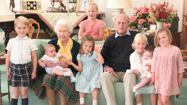 Queen Elizabeth and Prince Philip, with their great grandchildren. Pictured (L-R) are Britain's Prince George of Cambridge, Britain's Prince Louis of Cambridge being held by Britain's Queen Elizabeth II, Savannah Phillips (standing at rear), Britain's Princess Charlotte of Cambridge, Britain's Prince Philip, Duke of Edinburgh, Isla Phillips holding Lena Tindall, and Mia Tindall.