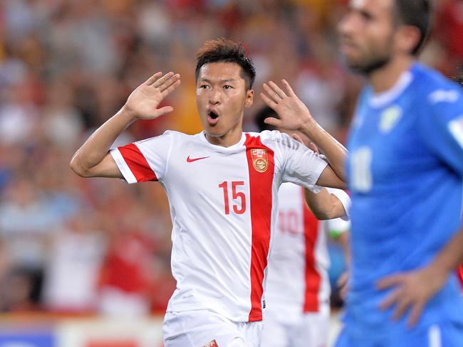 BRISBANE, AUSTRALIA - JANUARY 14: Wu Xi of China celebrates after scoring a goal during the 2015 Asian Cup match between China PR and Uzbekistan at Suncorp Stadium on January 14, 2015 in Brisbane, Australia. (Photo by Bradley Kanaris/Getty Images)